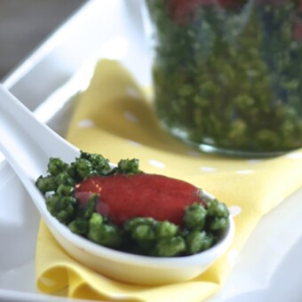 Spoon full of spinach, strawberry and barley baby food puree.