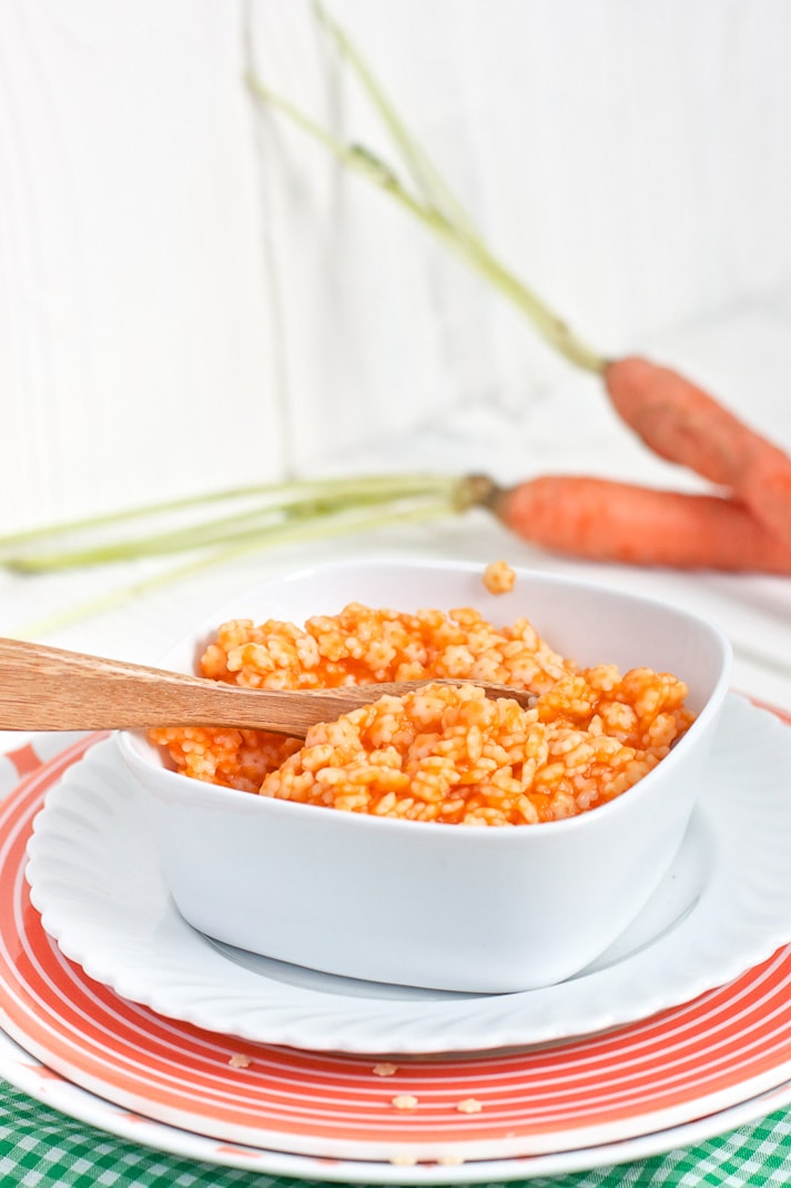 square white bowl filled with chunky carrot pasta.