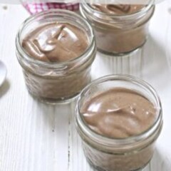Chocolate chia pudding in three glass jars.