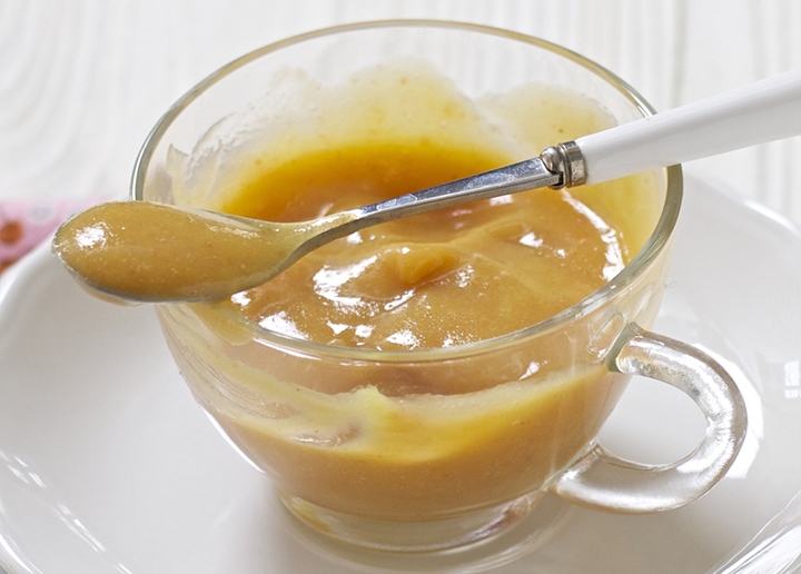 Small clear bowl filled with a thick and creamy homemade baby food puree.