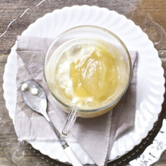 Clear bowl filled with apple puree and cottage cheese.