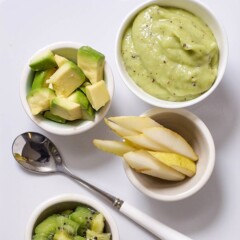 spread of food in small bowls and a smooth and creamy puree for baby.