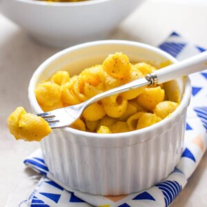 Small white bowl filled with healthy butternut squash Mac and cheese for toddler and kids.