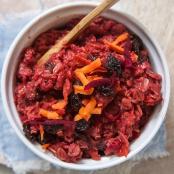 A bowl of homemade veggie oatmeal with beets and carrots.