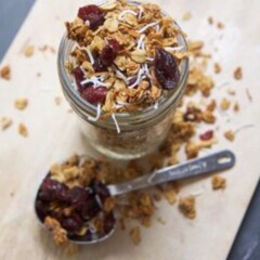 cranberry and coconut granola in a glass jar.