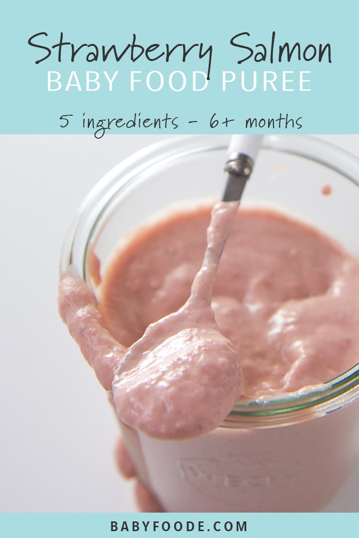 A jar of homemade roasted strawberry and salmon baby food puree with a baby spoon.