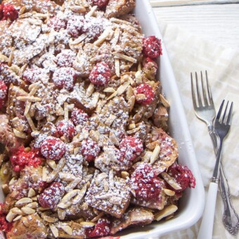 Raspberry almond baked french toast in a casserole dish.