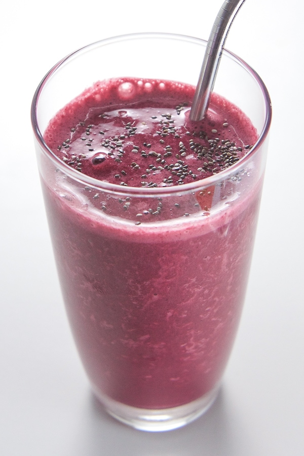 Kid friendly cherry beet smoothie in a pint glass with a metal straw. 