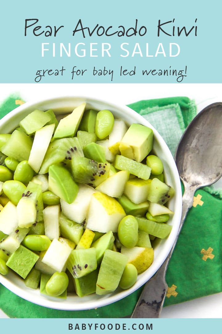 A baby led weaning finger salad in a white bowl with pear, avocado, kiwi, and edamame. 