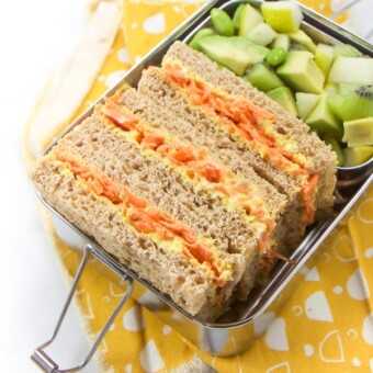 Kid friendly vegetarian sandwich with carrots and beets in a metal lunchbox.