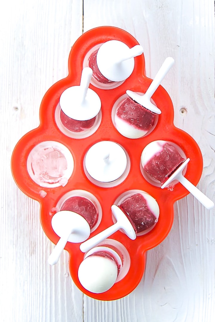 Sweet beet popsicles in a popsicle mold tra.