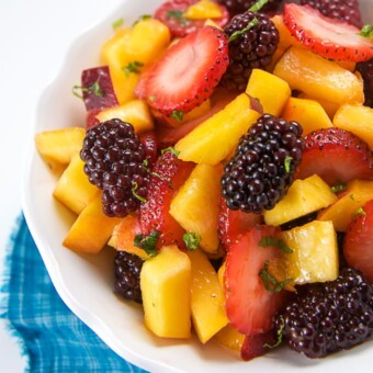 A bowl of peach and berry summer salad for toddlers and baby led weaning.