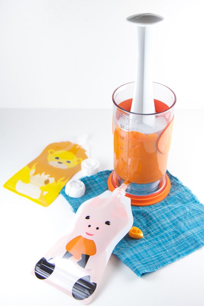 Reusable baby food pouches getting filled with immune boost baby food puree.