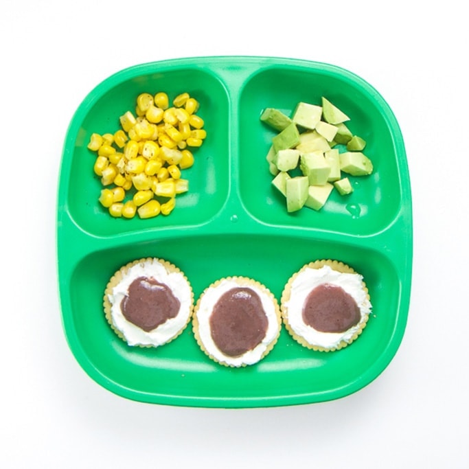 A healthy toddler meal on a green plate.