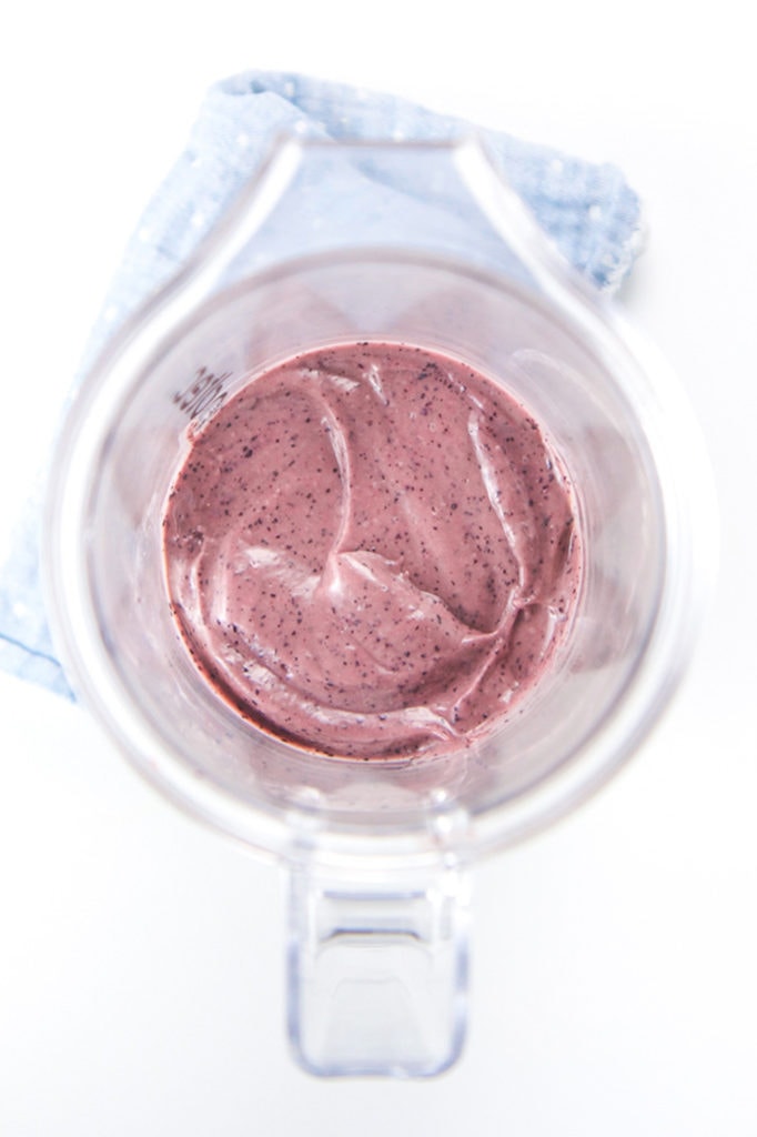Overhead shot of a clear blender with a baby food puree inside.
