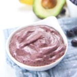 A bowl of fast and easy baby food puree with banana, blueberry, and avocado.