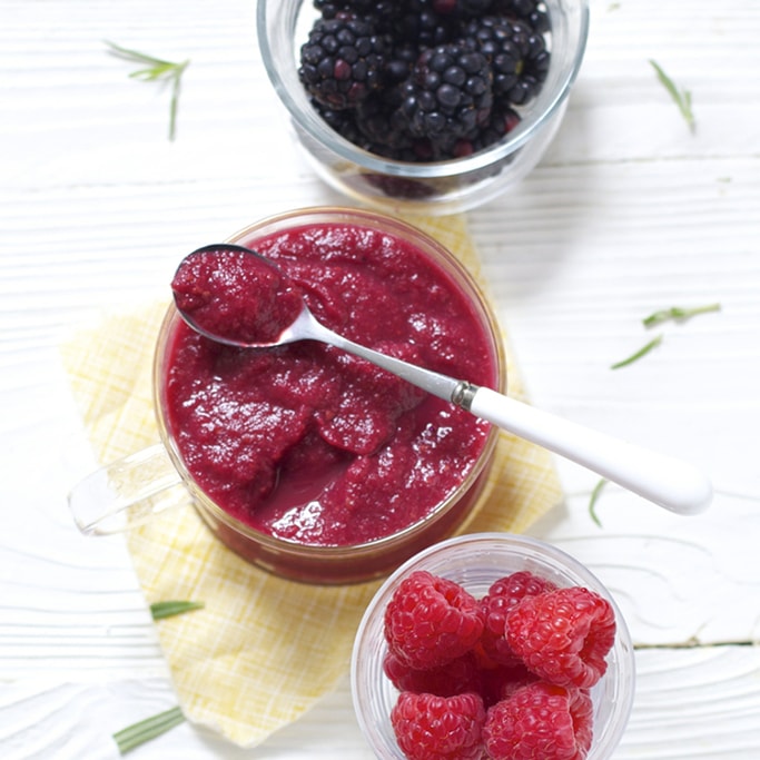 spread of bowls filled with berries and a finished Berry Puree. 