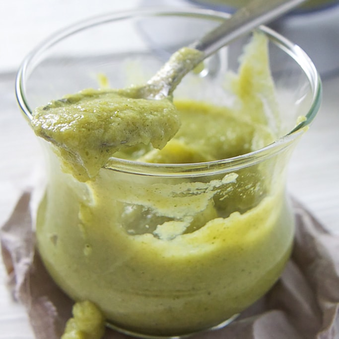 A small clear jar filled with a baby food puree for baby lunch.