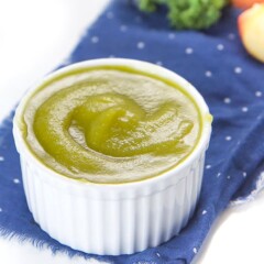 white bowl full of apple and kale baby food puree.