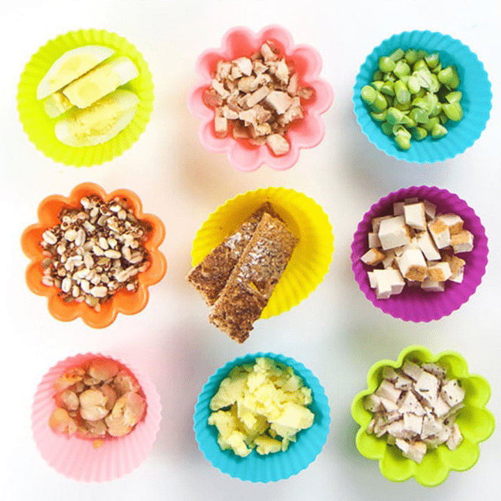 9 different colorful cups full of grains and proteins for baby.