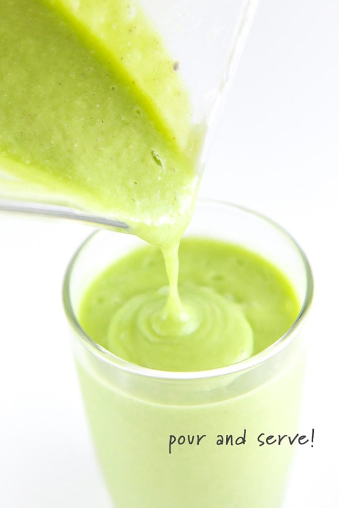 green smoothie pouring into a cup