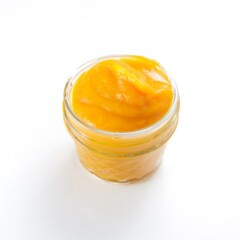small glass jar filled with a creamy organic baby food recipe sitting on a white background