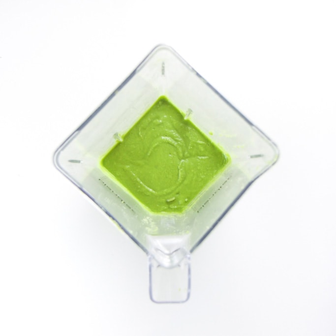overhead shot of a blender filled with a creamy green bean baby food puree