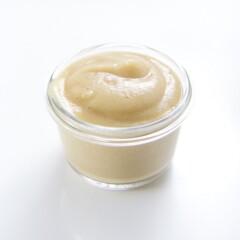 Image is of a small class jar with a smooth pear baby food puree inside