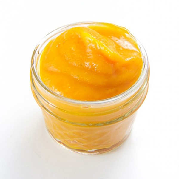 A small glass jar filled with butternut squash baby food puree. 