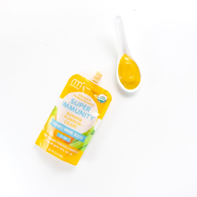 organic baby food brand pouch with a spoon filled with it's puree - stage two