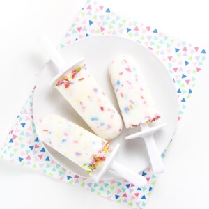A white plate with 3 healthy funfetti popsicles on top.