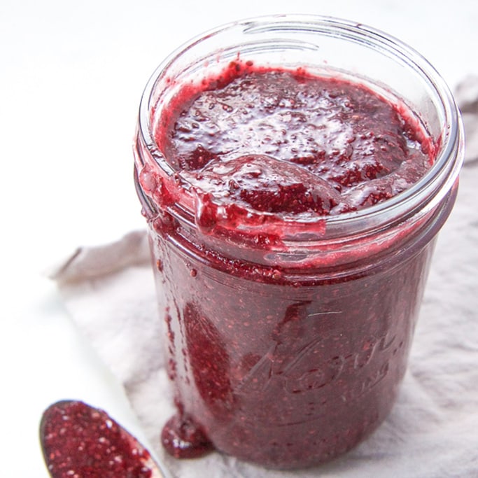 A clear jar filled with chia seed jam. 