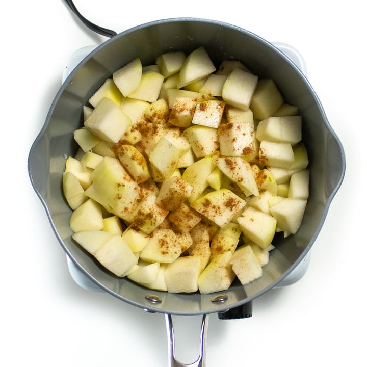 Saucepan with chopped pears and spices getting ready to book for a homemade baby food puree.