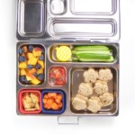 Stainless steel bento box for kids filled with healthy school lunch.