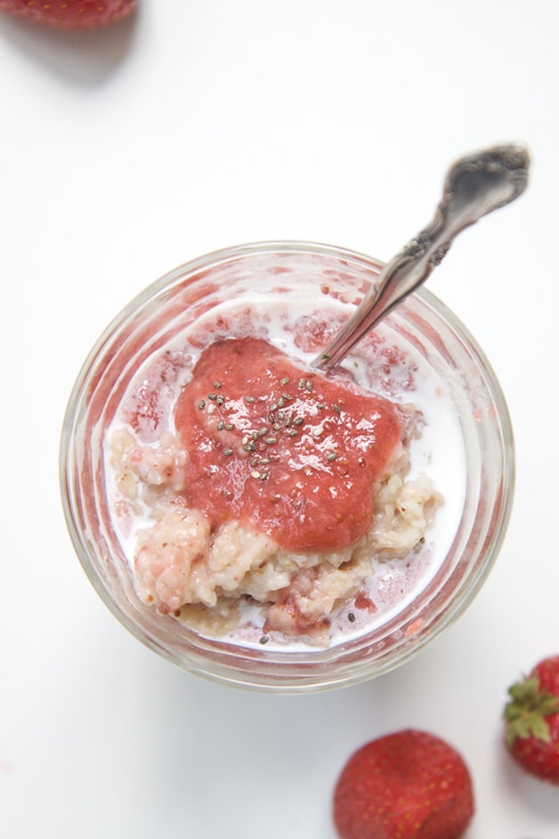 A clear class jar filled with strawberry chia seed oatmeal for baby + toddler.
