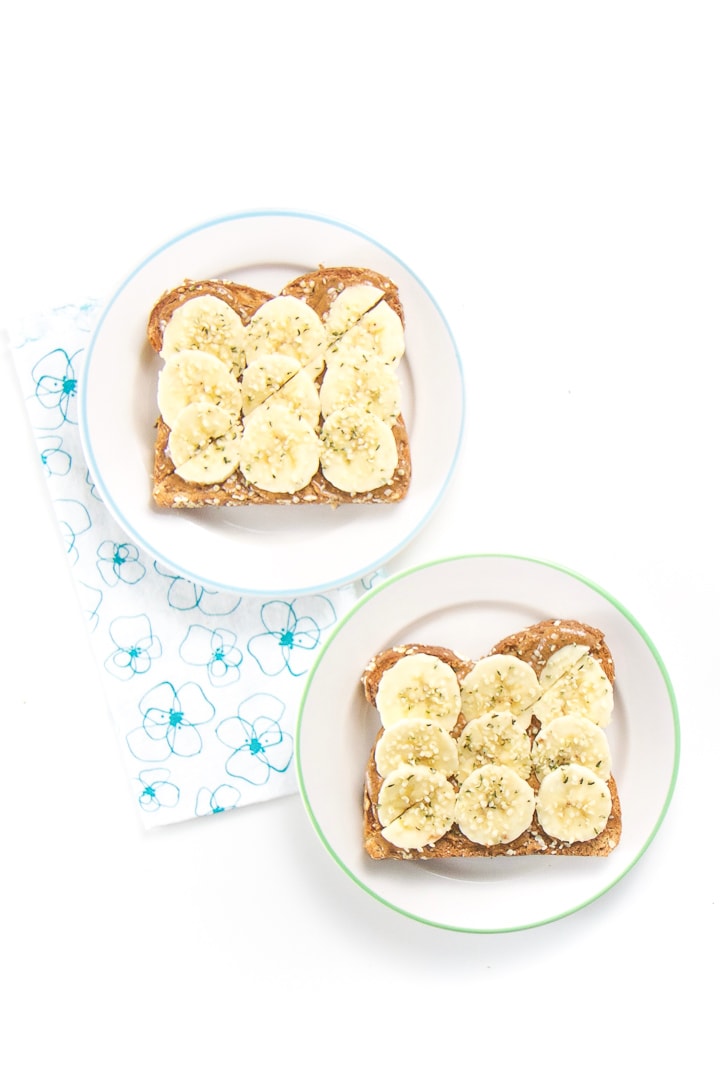 2 round white plates filled with almond toast for toddler.