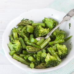 White bowl filled with green veggies for finger foods or baby-led weaning.