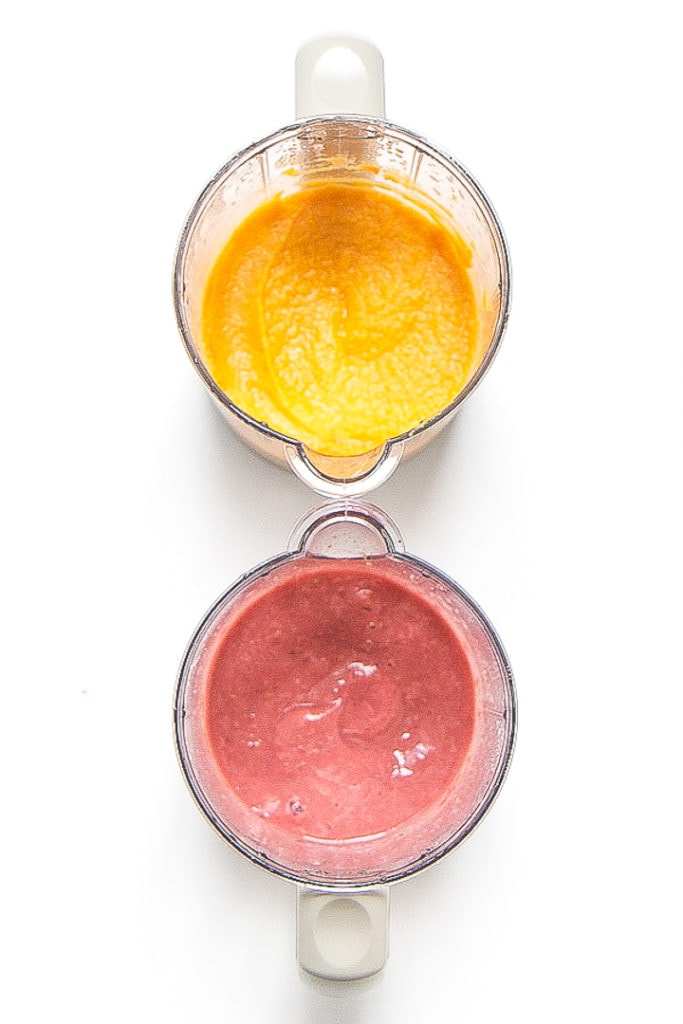 Image is of two blenders sitting next to each other.