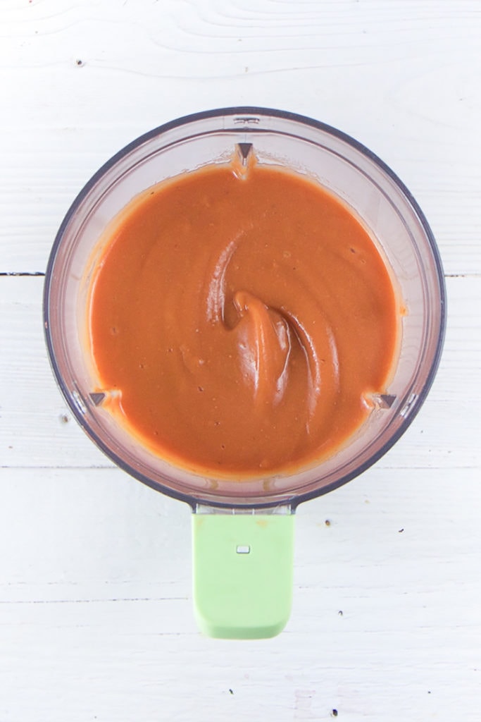 Blender with creamy homemade baby food puree.