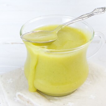 Small clear jar filled with homemade squash thyme baby food puree.