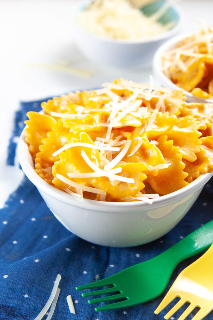 Up close of a bowl of pumpkin pasta with parmesan sprinkled on top - family favorite dinner.