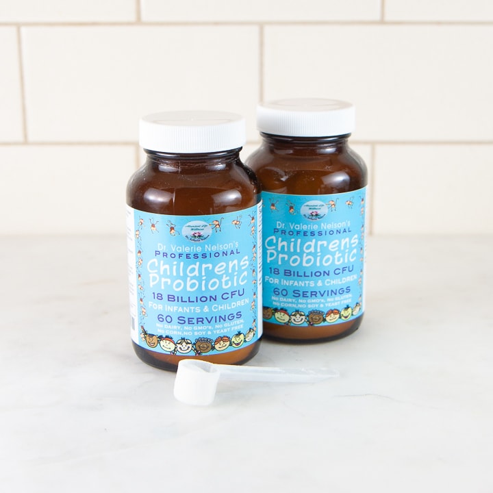 2 bottles of probiotics with a scoop in front.