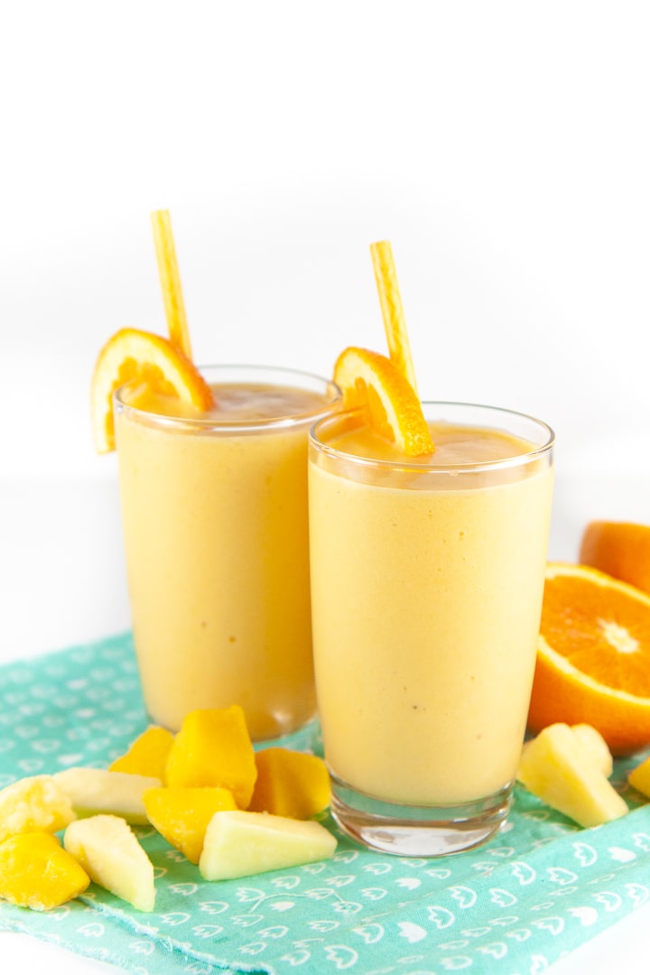 two toddler or kid smoothies with citrus fruit around it for toddler and kids