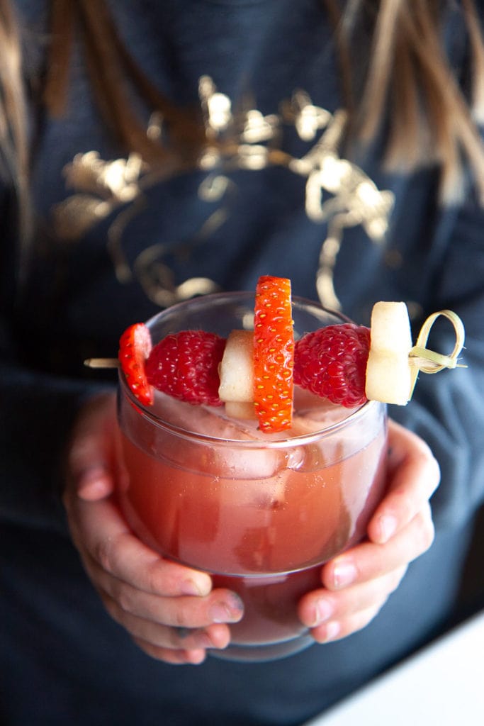 Small girl holding a glass of healthy Christmas punch