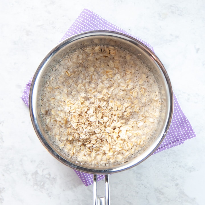 Saucepan filled with cooking oats.