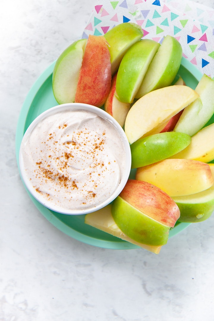 Spiced yogurt dip with a plate of apples.
