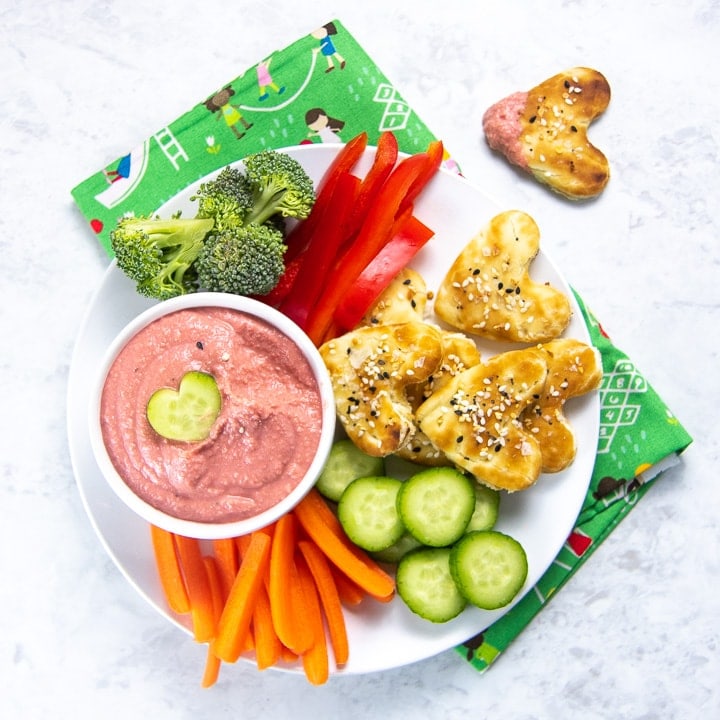 Beet Hummus for Baby, Toddler and kids with a variety of veggies and heart shaped pita chips.