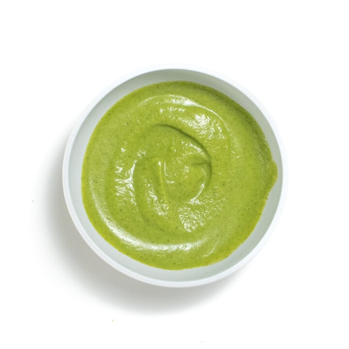 Gray bowl with a creamy broccoli puree for baby.