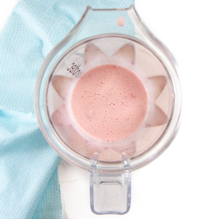 strawberry yogurt popsicles in a blender