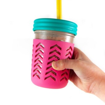 kids hand holding a colorful smoothie cup filled with hidden-veggie smoothie
